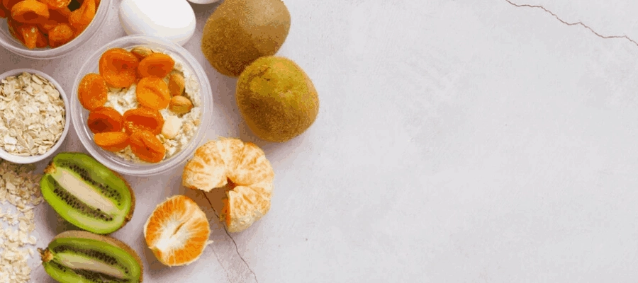 kiwi, laranja, tangerina ovos, iogurte e farelo de aveia sobre uma superfície plana e lisa