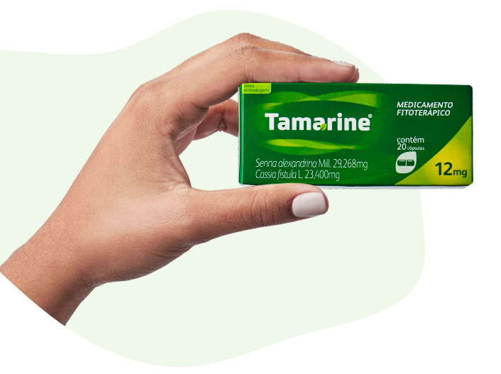 Imagem de uma mão segurando a embalagem do Tamarine Cápsulas 12mg